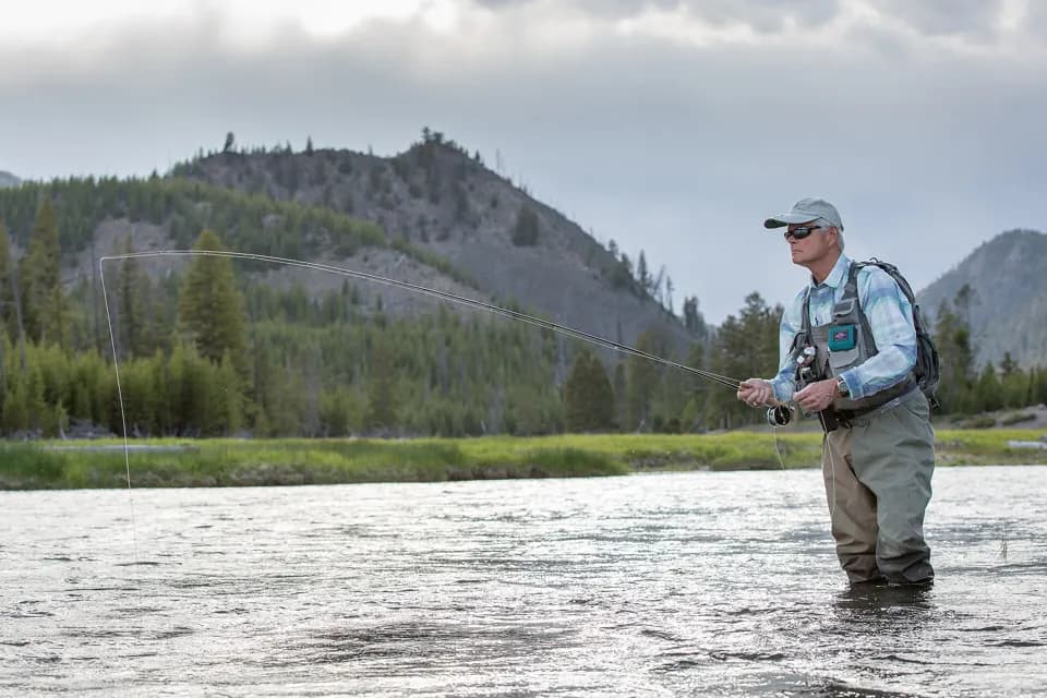 An angler casting on the Madison River in Yellowstone National Park